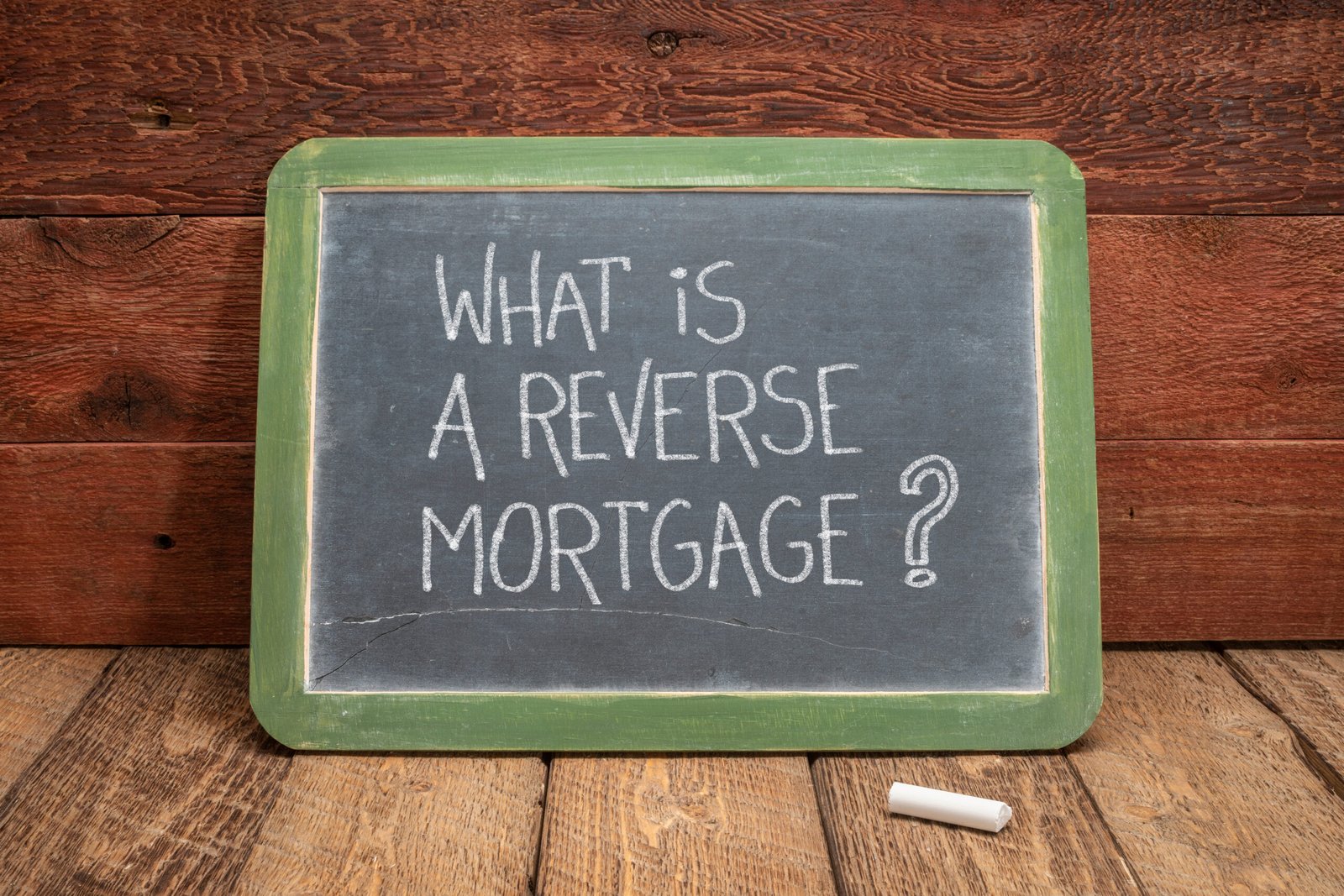 What is a reverse mortgage? A question written in white chalk on a slate blackboard, finance and retirement concept What-is-a-reverse-mortgage-loan